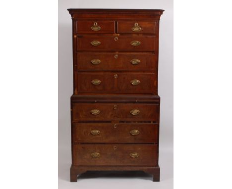 A George III walnut chest-on-chest, the upper section having feather and crossbanded graduated drawers within canted corners,