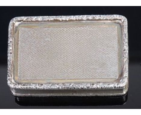 A George III silver pill-box, having a raised floral engraved border, with further engine turned decoration and gilt washed i