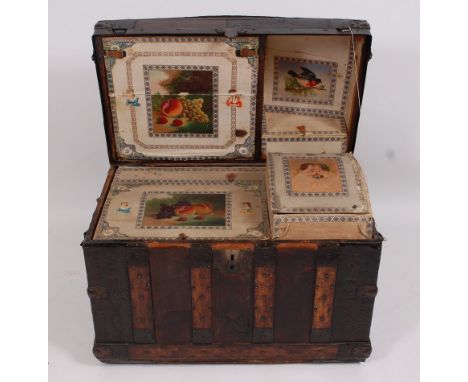 An early 19th century beech studded leather clad and iron bound dome-top travelling trunk, the hinged lid opening to reveal w