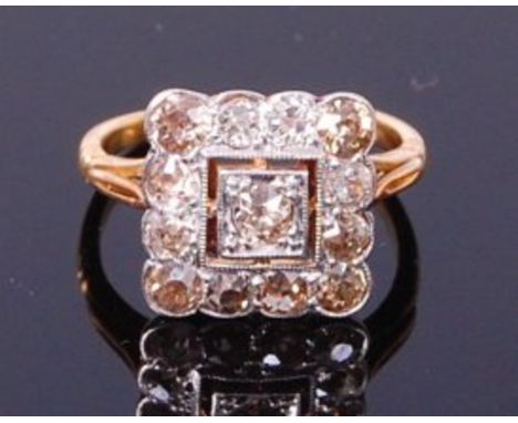 An Art Deco yellow gold diamond tablet ring, arranged as a centre old cut diamond in a square setting and within a surround o