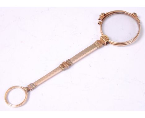 An early 20th century French gold lorgnette, the arm having engine turned decoration, stamped 385 to the bridge underside, 15