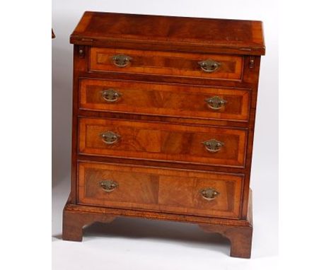 A mid-18th century style flame walnut curl feather and cross banded bachelors chest, having a fold-over top over four long gr