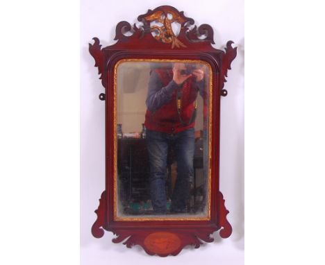*A 19th century mahogany and parcel gilt wall mirror, in the Chippendale style, having a bevelled plate and conch-shell marqu