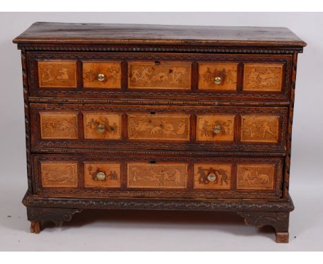 An 18th century Italian carved walnut and marquetry inlaid commode, having three long drawers with brass knob handles, raised