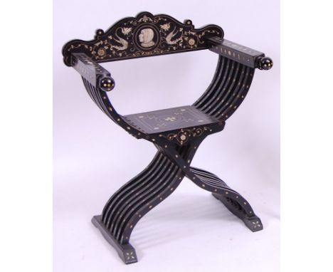 *A 19th century Continental ebonised and ivory inlaid X-framed chair, the back rail with penwork ivory decorated inlaid profi