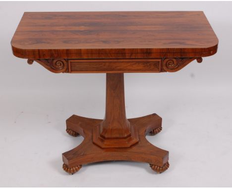 A Victorian rosewood card table, the D-shaped fold-over top revealing baize lined playing surface, on octagonal column, platf