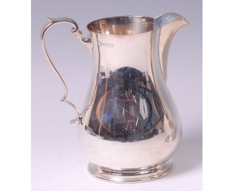 A George VI silver jug, of bell shape, having flying C-scroll handle, maker Harrison Brothers & Howson, Sheffield 1932, 12.6o