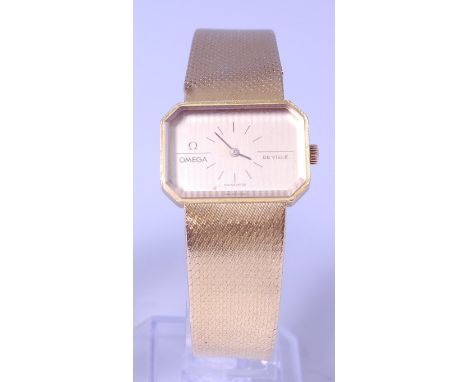 A gents Omega DeVille 18ct gold cased bracelet watch, the two-tone rectangular dial signed Omega DeVille, with canted corners