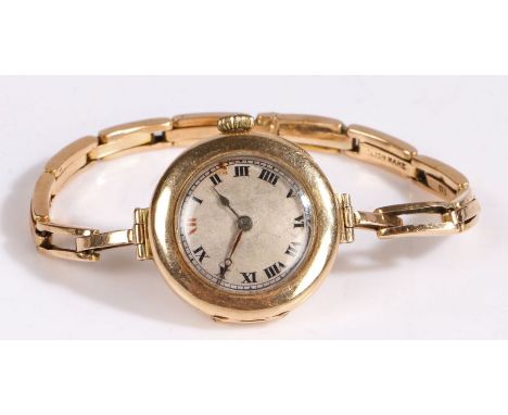 An early 20th century 15 carat gold manual wind Rolex ladies wristwatch, with a silvered dial with roman numerals the twelve 