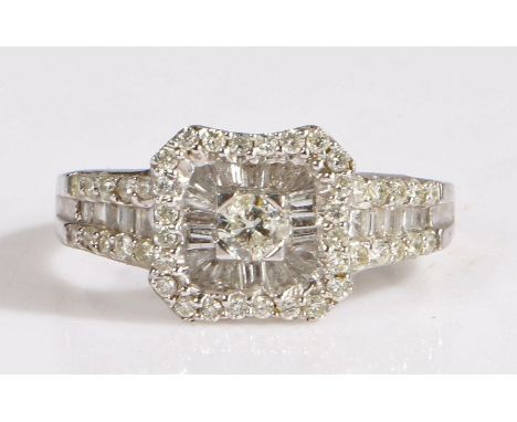 A 9 carat white gold and diamond ring, the head set with a central diamond approx 0.15 carat surrounded by baguette and round