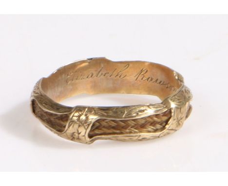 A mid 19th century unmarked gold coloured mourning ring, the ring with hair woven through out the ring, with a inscription to