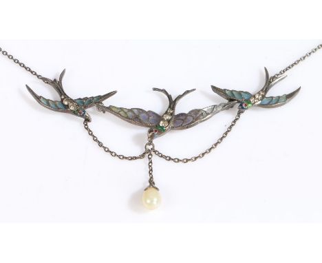 An antique silver and enamel/glass necklace formed of three swallows, each with a red gemset eye and three white stones to th
