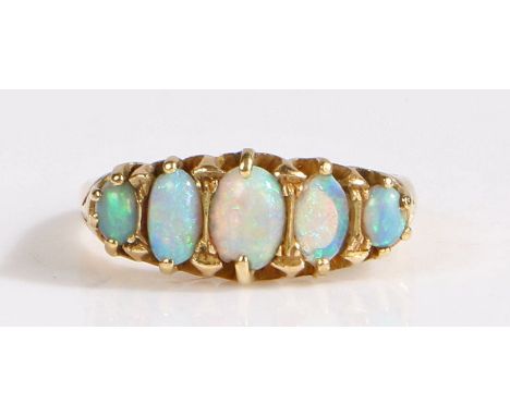 An 18 carat gold and opal ring, set with five graduated cabochon white opals in claw setting, 5.12 grams, ring size P