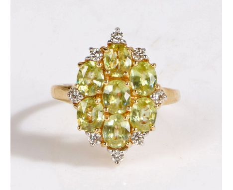 A 18 carat gold capelinhha sphene and diamond cluster ring, the head set with seven oval cut capelinha sphenes and eight diam