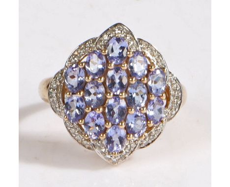 A 9 carat gold diamond and purple stone cluster ring, the head set with fourteen purple stones together with diamonds around 