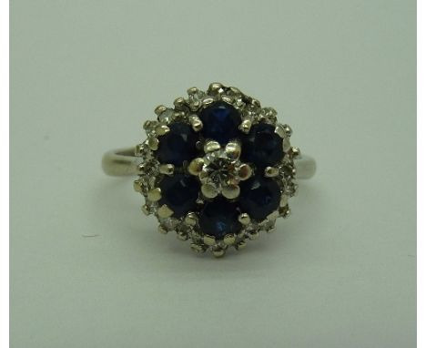 A c.1970's 18ct white gold, sapphire and diamond cluster ring, weight 4.8g, size L