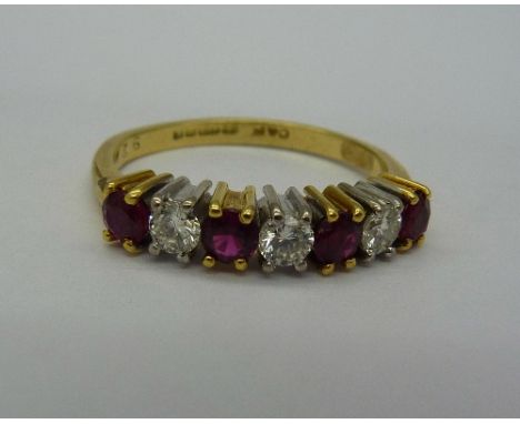 An 18ct gold, ruby and diamond seven stone ring, approximately 0.3ct diamond weight and 0.4ct ruby weight, weight 3.6g, size 