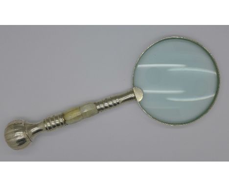 A magnifying glass with mother of pearl handle