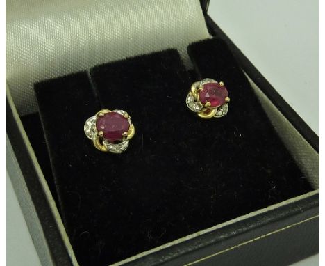 A pair of ruby and diamond ear studs marked 925