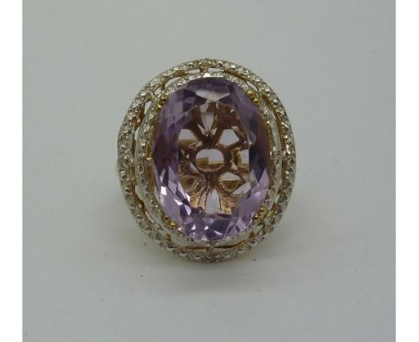 A large silver gilt, amethyst and diamond ring, size S