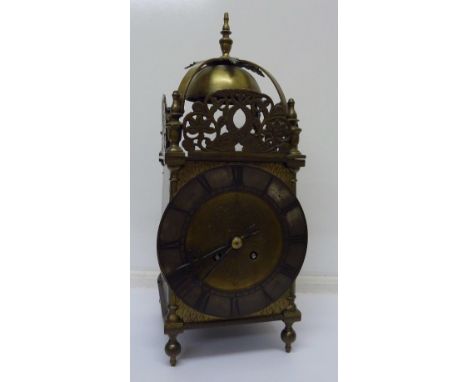 A c.1900 large lantern brass clock with key and pendulum