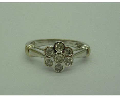 A 14ct white gold, diamond daisy cluster ring, weight 2.7g, size N