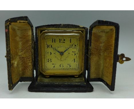 A travel alarm clock with case