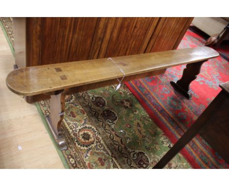 A 19th Century fruitwood cloakroom bench, exposed joints, vase end supports, width 180cm