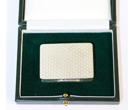 An Elizabeth II silver snuff box with engine turned decoration, gadrooned thumb piece, gilt interior, the base engraved with 