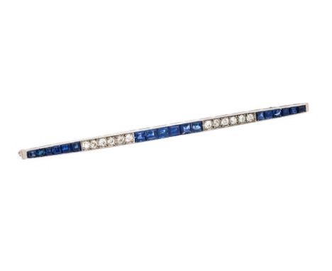 An Art Deco 15ct white gold and platinum diamond and sapphire bar brooch, set with alternating graduated square cut sapphires