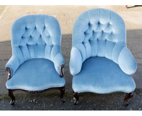 Two Victorian carved walnut and upholstered button back armchairs, comprising a Gentleman's and a Lady's armchair, upholstere