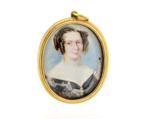 A mid 19th Century mourning pendant, the gilt metal frame inset with an oval portrait miniature on ivory of a lady, the rever