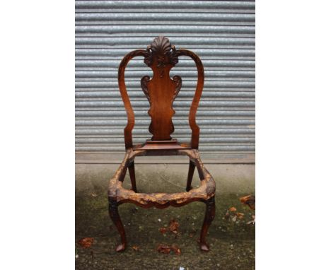 A George I walnut and beech framed side chair frame, possibly Dutch, the back with a shell carved crest rail, foliage carved 