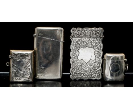 A George V silver shaped rectangular card case, wavy rim the body engraved with foliage and vacant shield shaped cartouche, J