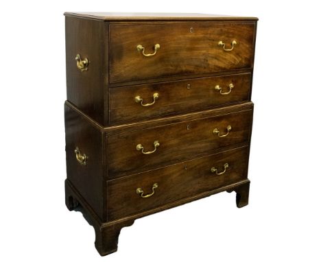 A George III mahogany campaign bureau, circa 1770, in two sections with brass swing side handles, moulded top, pull-out writi