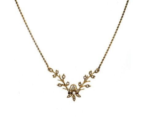 A late Victorian/Edwardian seed pearl set yellow gold pendant necklace, floral and leaf pendant set with small seed pearls to