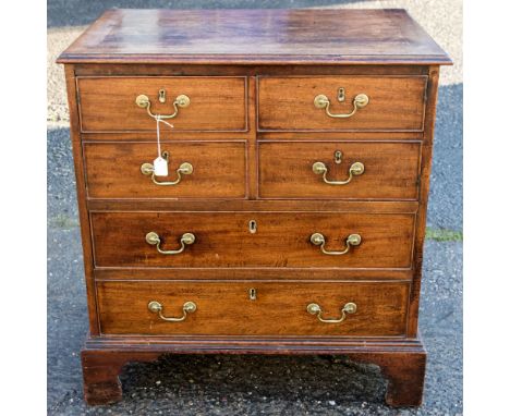 A George III mahogany side cabinet, fitted with two doors in the form of dummy drawers, raised on bracket feet, 71cm high, 69