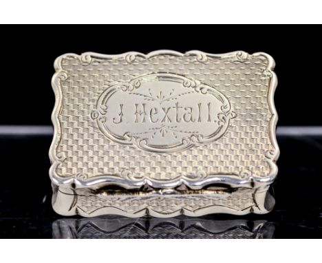 A Victorian silver small snuff box, shaped recangular with engine turned decoration, the cover with shaped oval cartouche and