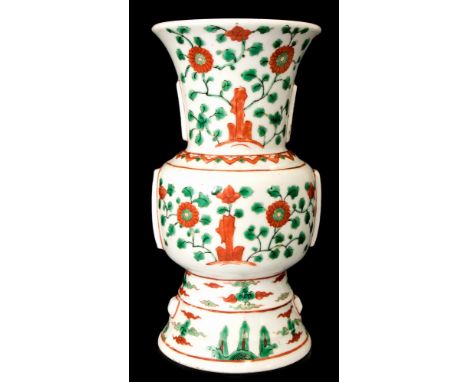 An archaistic Ming style Gu beaker vase, with Wanli mark, 19th Century, painted with red and green enamels with rocks and lea