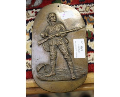 A bronze plaque of A Gentleman in Khaki, a trench art shell case, a tin featuring The Jungle Book Charles Kingsley and many C
