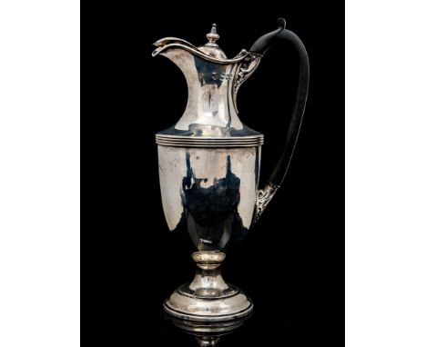 A late Victorian silver claret jug, plain urn-shaped body on stepped circular base, ebonised C-scroll handle terminating with