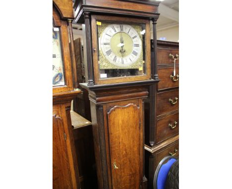 An oak longcase clock case, with a square cornice, complete with associated face and mechanism, complete with a Jonas Barber 