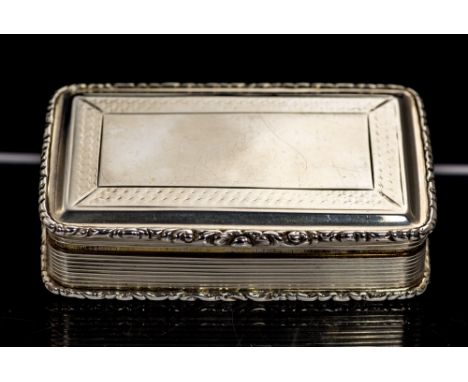 A Victorian silver snuff box, the hinged cover and base with engine turned decoration, the sides with chased with reeded desi