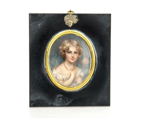 A Regency oval portrait miniature of a young girl, circa 1825, possibly on ivory, wearing a coral bead necklace and a white d