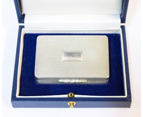 An Elizabeth II silver snuff box with engine turned decoration, the hinged over with vacant rectangular cartouche, the base c