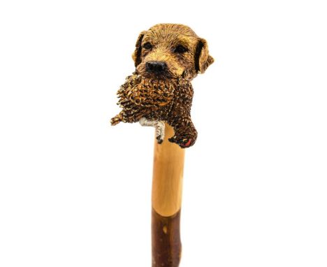 Ian Taylor, a fine hand crafted walking stick, the handle finely carved in the form of a Labrador retrieving a Red Grouse, co