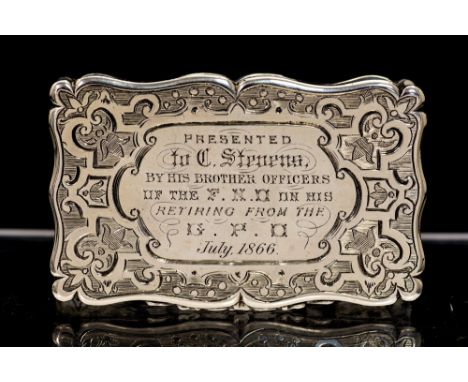 A Victorian silver snuff box, cartouche shaped the hinged cover and body engraved with geometric patterns, gilt interior, the