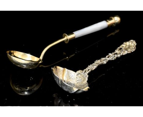 A Victorian silver-gilt ornate sauce ladle, the shaped bowl engraved fruit, the stem cast as a weaving vine with bunches of g