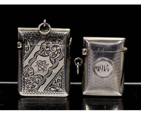 An Edwardian silver vesta case, engraved with foliate decoration and central monogram, Arthur Cook, Birmingham, 1902 and anot