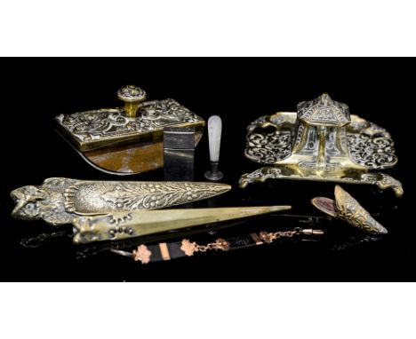 A collection of late 19th Century desk requisite writing ware including inkwell with ceramic pot, the body chased with foliag